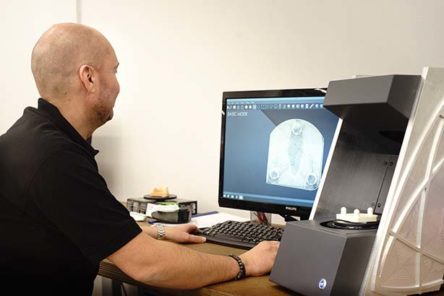 Man working with DentalCad software and Dscan 3D scanner